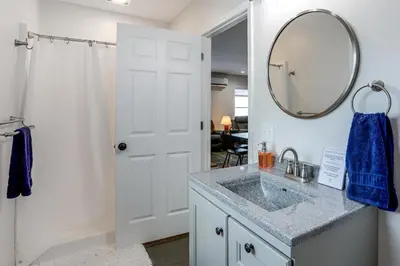 a bathroom with a sink and a mirror at Patio and Parking! Modern Bunkhouse Near Lake Erie in Oak Harbor