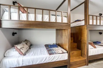 two bunk beds in a room with a bed at Patio and Parking! Modern Bunkhouse Near Lake Erie in Oak Harbor