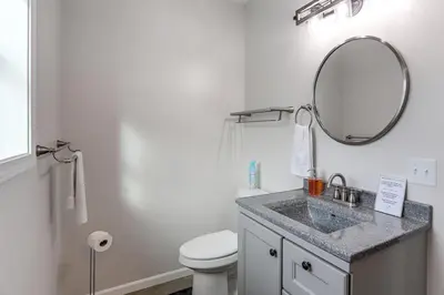 a bathroom with a sink and a mirror at Patio and Parking! Modern Bunkhouse Near Lake Erie in Oak Harbor