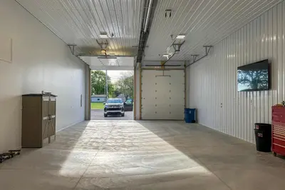 an empty garage with a car parked in it at Patio and Parking! Modern Bunkhouse Near Lake Erie in Oak Harbor