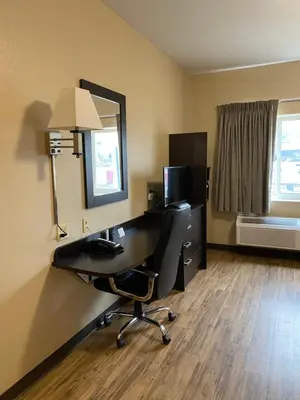 an office with a desk and a chair and a mirror at Suburban Studios Washington, PA in Washington