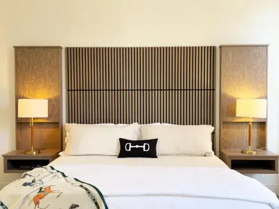 a bedroom with a bed with a black purse on it at Hotel Thoroughbred in Paris