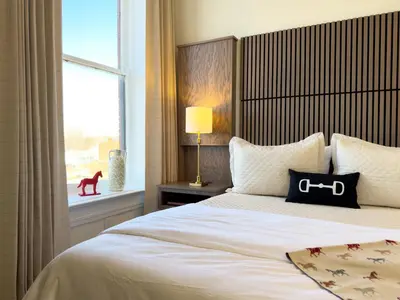 a bedroom with a large bed with a window at Hotel Thoroughbred in Paris