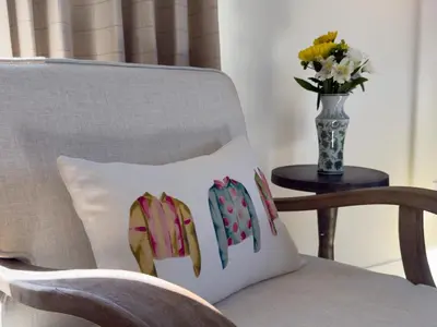 a pillow on a chair with a vase of flowers at Hotel Thoroughbred in Paris
