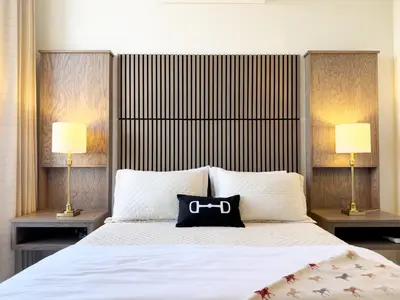 a bedroom with a bed with a black bag on it at Hotel Thoroughbred in Paris