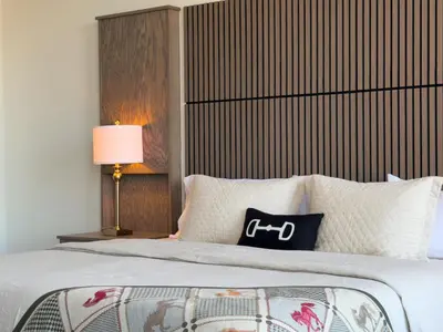 a bedroom with a large bed with a lamp and pillows at Hotel Thoroughbred in Paris