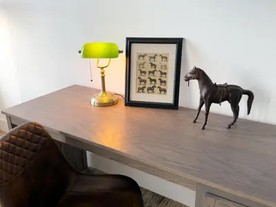 a statue of a horse on a desk with a lamp at Hotel Thoroughbred in Paris