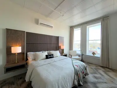 a bedroom with a large bed and a large window at Hotel Thoroughbred in Paris