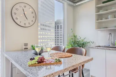 a kitchen with a table with a plate of food and a clock at Skyline Sanctuary in Cleveland