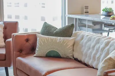 a brown couch with pillows on it in a living room at Skyline Sanctuary in Cleveland