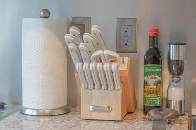 a knife block with a bunch of knives and a bottle of wine at Skyline Sanctuary in Cleveland