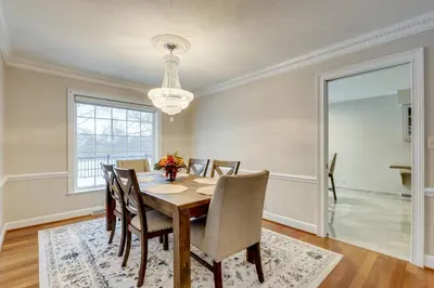 a dining room with a table and chairs and a chandelier at 7 Mi to Dtwn Toledo Spacious Family Home! in Perrysburg