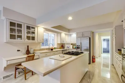 a kitchen with white cabinets and a counter top at 7 Mi to Dtwn Toledo Spacious Family Home! in Perrysburg