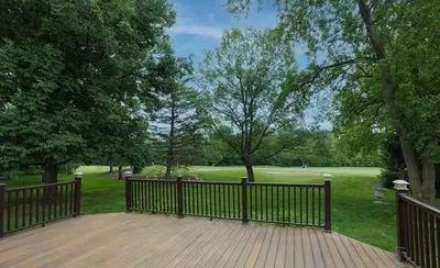 a wooden deck with a fence in a park at 7 Mi to Dtwn Toledo Spacious Family Home! in Perrysburg