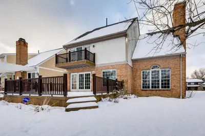 a brick house with a snow covered yard at 7 Mi to Dtwn Toledo Spacious Family Home! in Perrysburg