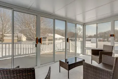 a room with windows and a table and chairs at 1 mile to Downtown! Boat, Hike and Fish in Liberty