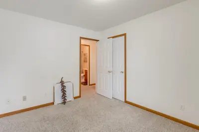 an empty living room with white walls and a mirror at 1 mile to Downtown! Boat, Hike and Fish in Liberty
