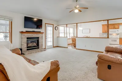 a living room with a couch and a fireplace at 1 mile to Downtown! Boat, Hike and Fish in Liberty