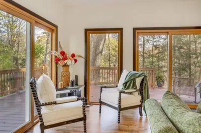 a living room with two chairs and a couch on a porch at Trails, Wine and Events! Cuyahoga Falls Retreat in Cuyahoga Falls