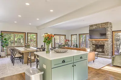 an open kitchen and living room with a fireplace at Trails, Wine and Events! Cuyahoga Falls Retreat in Cuyahoga Falls