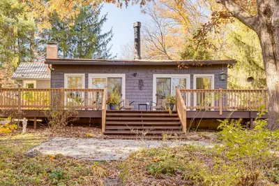 a small house with a porch and a deck at Trails, Wine and Events! Cuyahoga Falls Retreat in Cuyahoga Falls