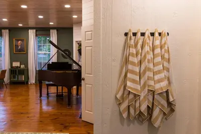 a room with a piano and a door with a curtain at Cozy Spring Night HotTub Firepit PetFriendly Patio in McArthur