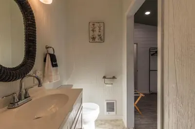 a bathroom with a sink and a toilet at Cozy Spring Night HotTub Firepit PetFriendly Patio in McArthur