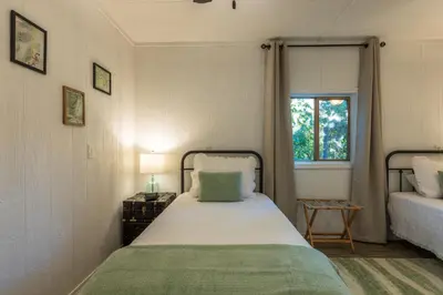 a small bedroom with a bed and a window at Cozy Spring Night HotTub Firepit PetFriendly Patio in McArthur