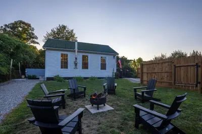 a backyard with chairs and a fire pit and a house at Cozy Spring Night HotTub Firepit PetFriendly Patio in McArthur