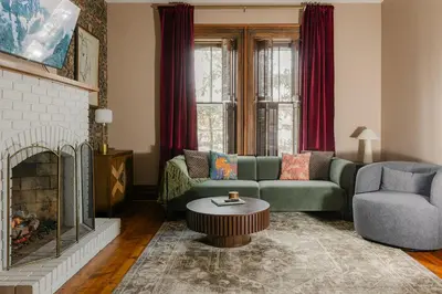 a living room with a couch and a fireplace at 1868 Historic Victorian, 4Bed-4Bath, Downtown Loudonville, Sleeps 10 in Loudonville