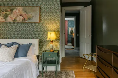 a bedroom with a bed and a lamp on a night stand at 1868 Historic Victorian, 4Bed-4Bath, Downtown Loudonville, Sleeps 10 in Loudonville