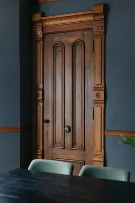 a wooden door with four chairs in front of a table at 1868 Historic Victorian, 4Bed-4Bath, Downtown Loudonville, Sleeps 10 in Loudonville