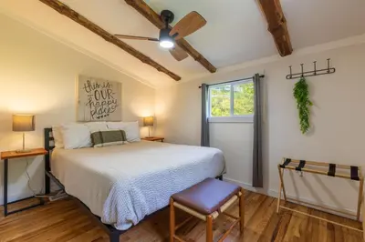 a bedroom with a bed and a ceiling fan at Lakefront Vibes Lake Access•Hot Tub•Firepit•Pets in Rockbridge