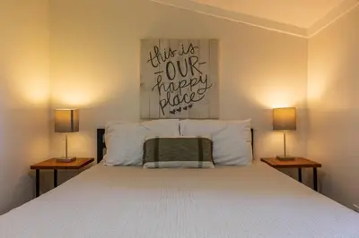 a bedroom with a bed with two lamps on both sides at Lakefront Vibes Lake Access•Hot Tub•Firepit•Pets in Rockbridge