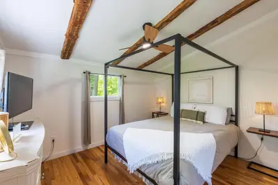 a bedroom with a canopy bed and a desk at Lakefront Vibes Lake Access•Hot Tub•Firepit•Pets in Rockbridge