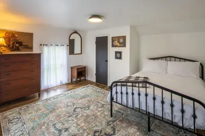 a bedroom with a bed and a dresser at Nature-Quiet Retreat • Firepit BBQ • PetFriendly in McArthur