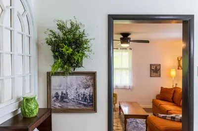 a living room with a mirror and a couch at Nature-Quiet Retreat • Firepit BBQ • PetFriendly in McArthur