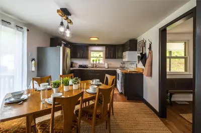 a kitchen and dining room with a table and chairs at Nature-Quiet Retreat • Firepit BBQ • PetFriendly in McArthur