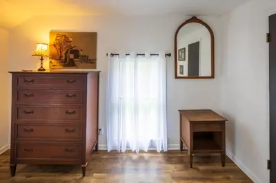 a bedroom with a dresser and a mirror at Nature-Quiet Retreat • Firepit BBQ • PetFriendly in McArthur