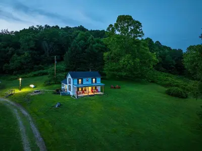 a small house on a green field with trees at Nature-Quiet Retreat • Firepit BBQ • PetFriendly in McArthur