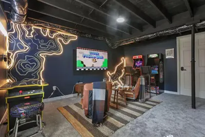 a room with a video game room with chairs and consoles at Edens Hillside Haven in Laurelville