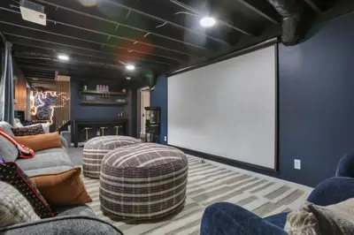 a living room with two couches and a large screen at Edens Hillside Haven in Laurelville