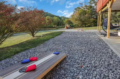 two flip flops sitting on a bench next to a river at Edens Hillside Haven in Laurelville
