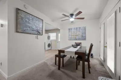 a dining room with a table and a ceiling fan at Home to Unwind in Columbus