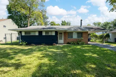 a house with a roof on top of a yard at Home to Unwind in Columbus