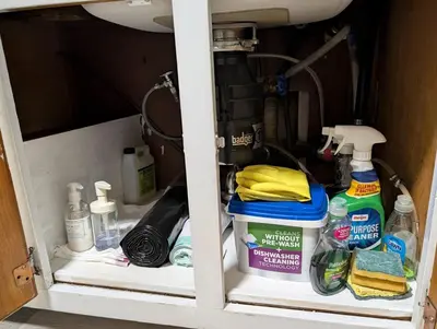 a cabinet filled with lots of cleaning products at Home to Unwind in Columbus