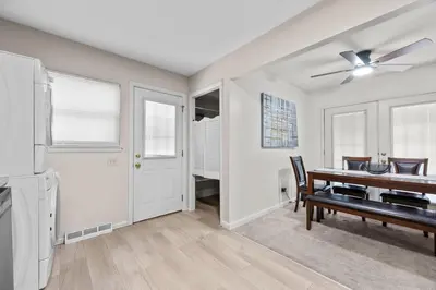 a dining room with a table and a ceiling fan at Home to Unwind in Columbus
