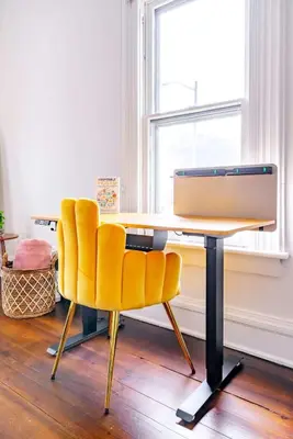 a desk with a computer and a yellow chair at Yoctangee House by Jungle House in Chillicothe