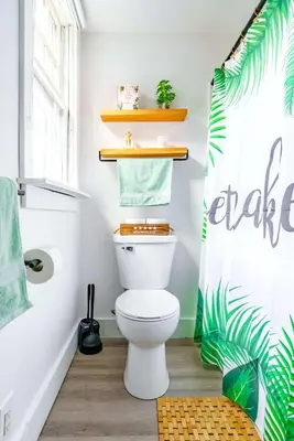 a bathroom with a toilet and a shower curtain at Yoctangee House by Jungle House in Chillicothe
