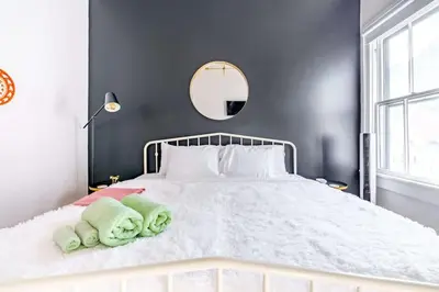 a bedroom with a white bed with towels on it at Yoctangee House by Jungle House in Chillicothe